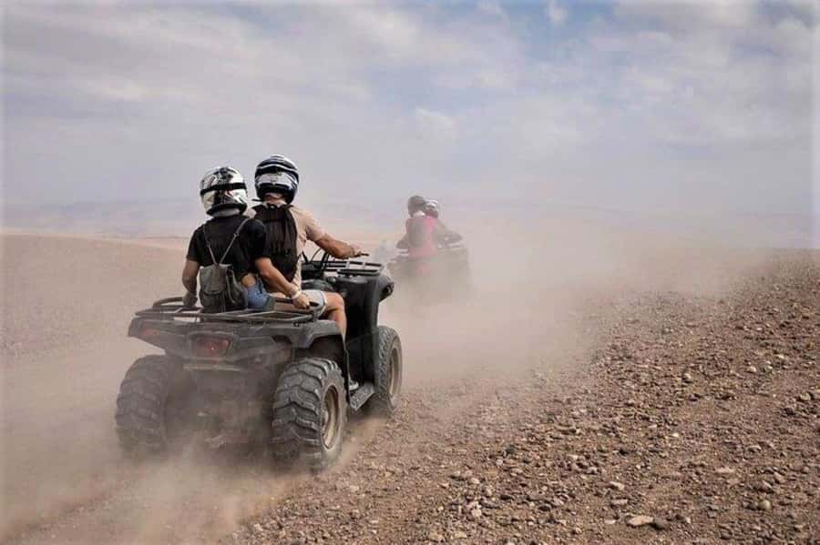 Marrakech: Agafay Desert Quad Biking with Dinner & Show - Sharing the quad across rocky ground