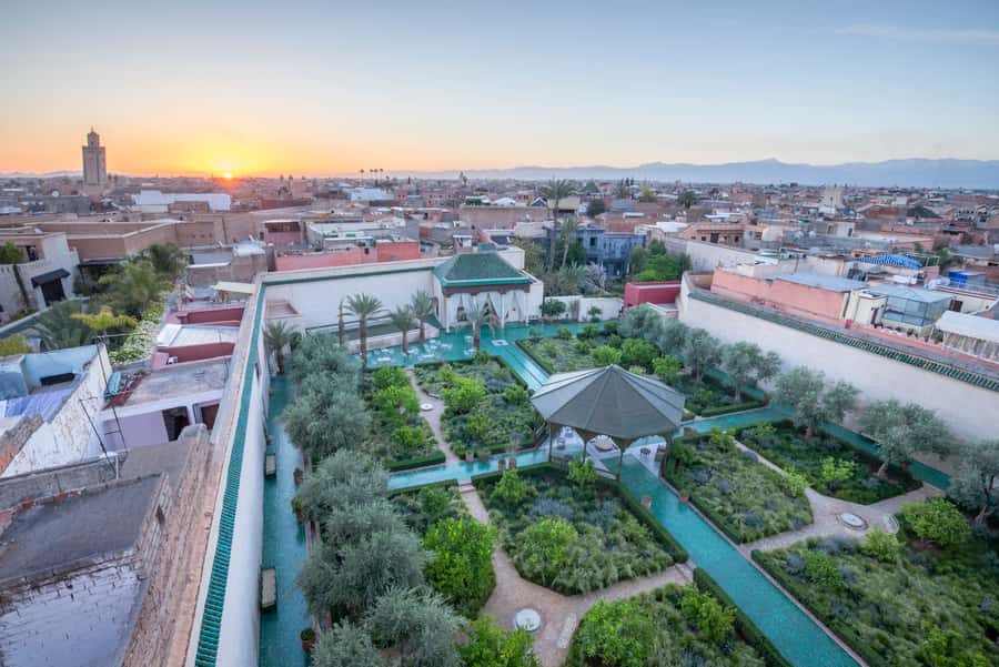 Marrakech: Guided City and Gardens Highlights Tour - Menara Garden and views toward the Atlas Mountains
