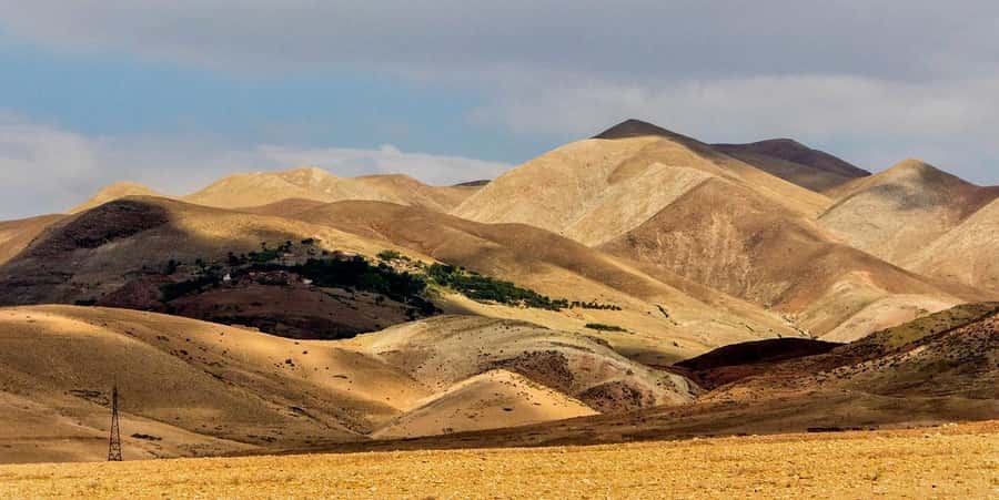 Marrakesh: Desert & Mountain Tour with Camel Ride & Lunch - Camel riding across rocky Agafay