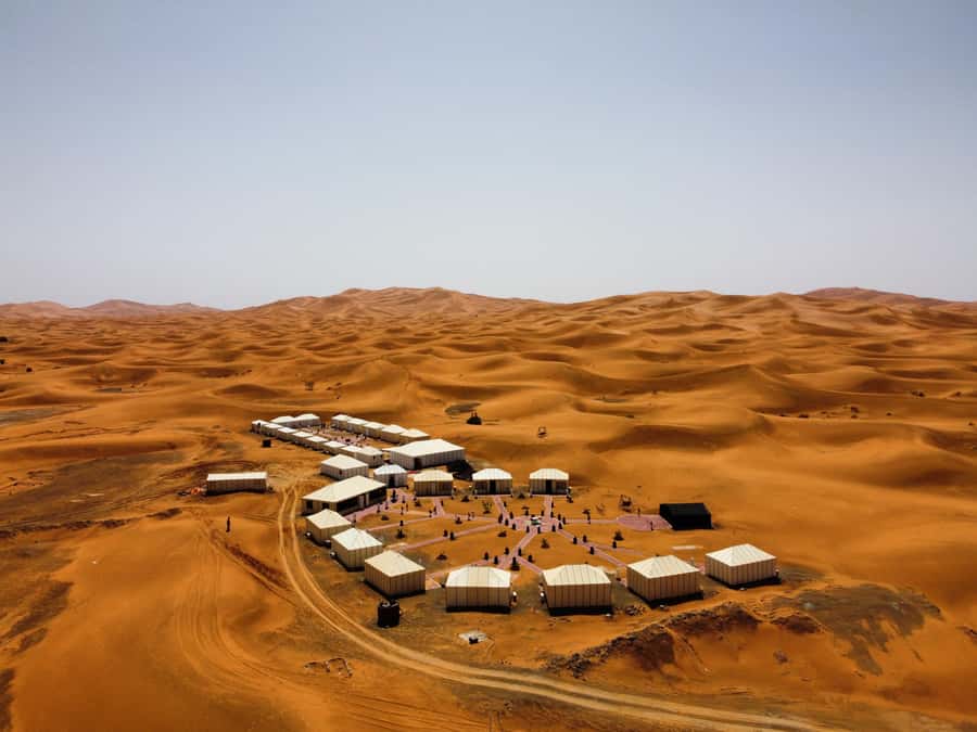 Merzouga: Overnight Stay in Luxury Desert Tent with Dinner - Tea, a private tent, and the camp after dark
